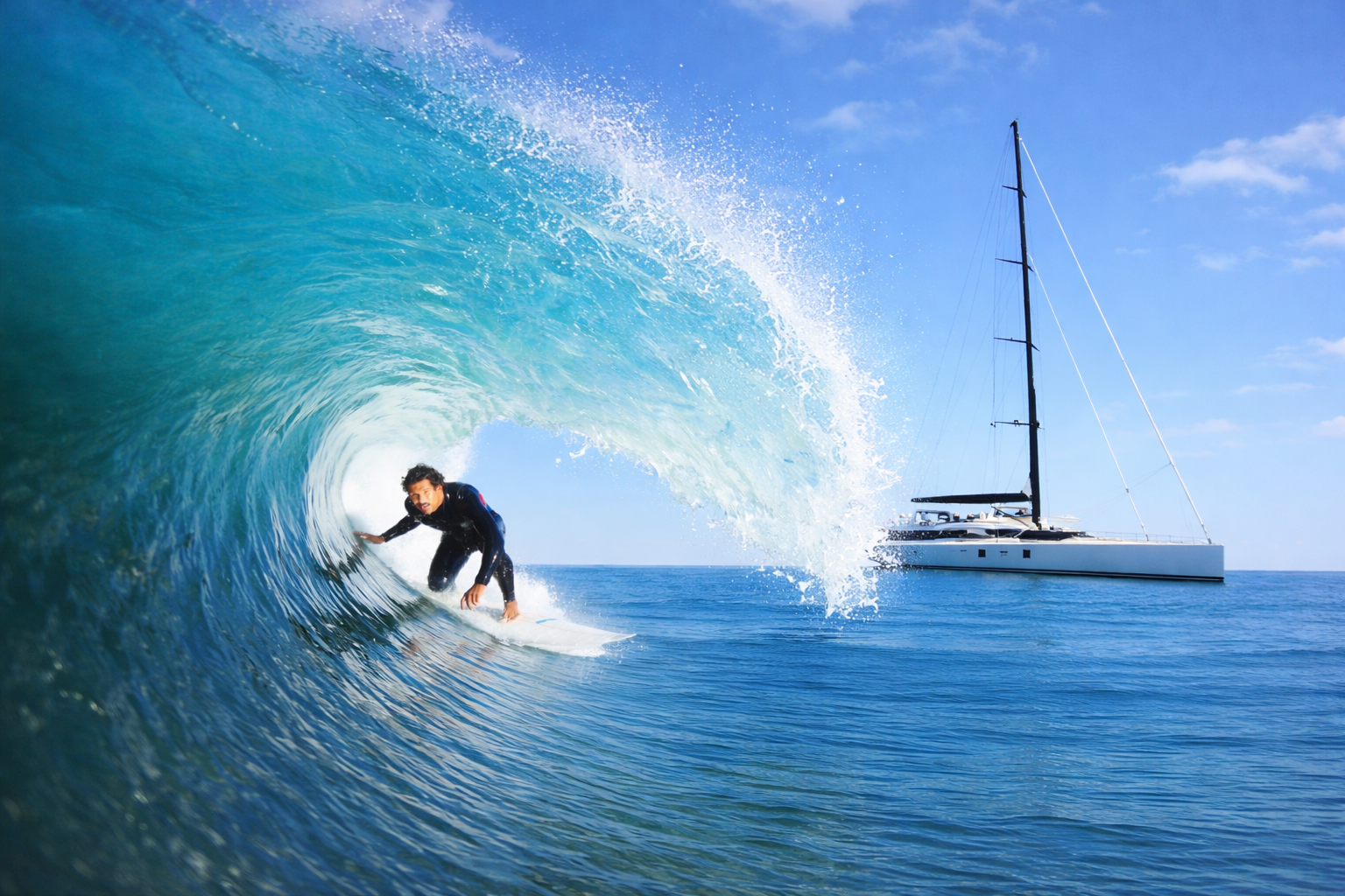 sail yacht pacific with surfer